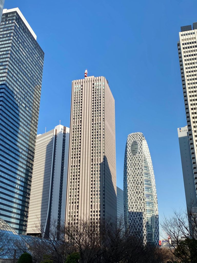 A low-angle view of Shinjuku skyscrapers in Tokyo, showcasing modern architecture.